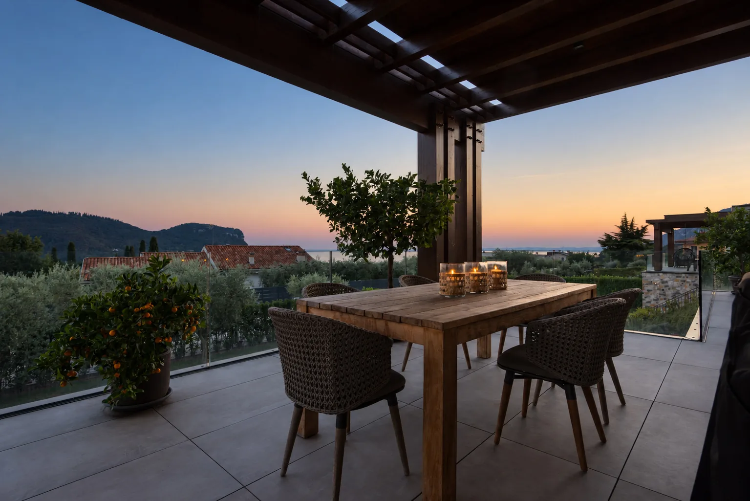 Covered terrace dining table with candles and a view across the hills at sunset. | Only on SopranoVillas